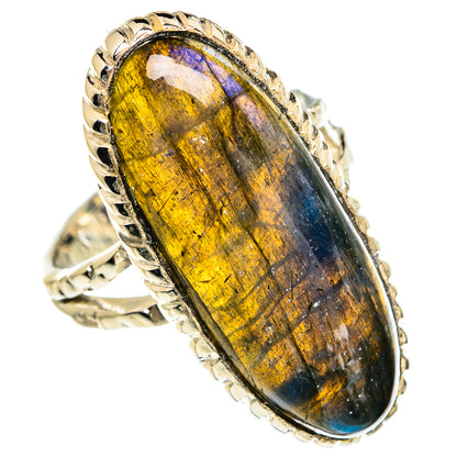 Oval labradorite ring with gold and blue shimmer, silver bezel and decorative band