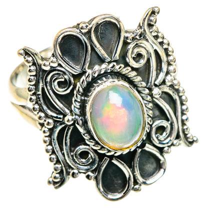 Sterling silver opal ring with oval rainbow opal center and dark oval accents
