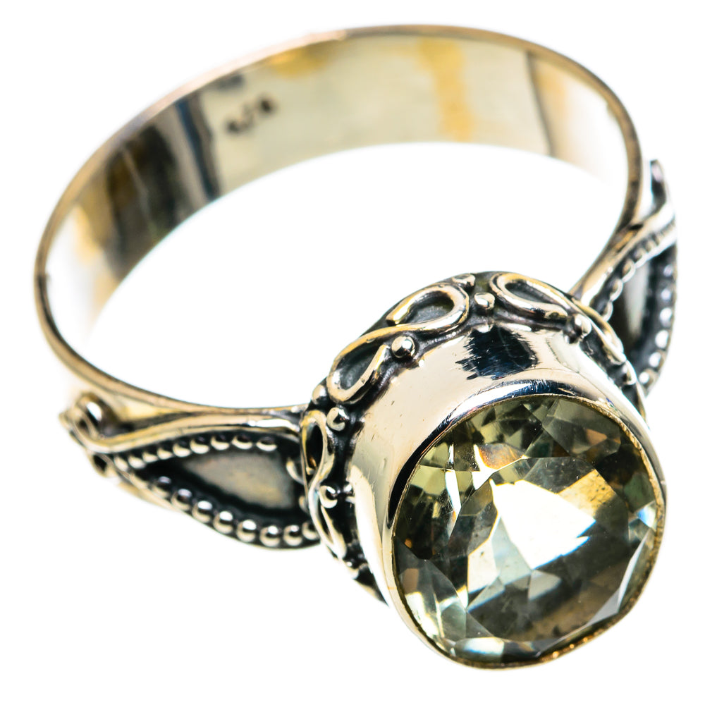 Sterling silver ring with bezel-set faceted green stone and detailed side filigree