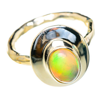 Sterling silver opal ring with round iridescent green-orange gemstone, polished band