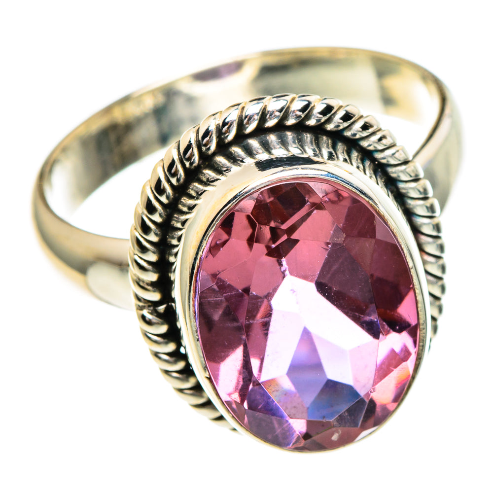 Metal ring with oval gemstone and twisted rope bezel, pink center stone.