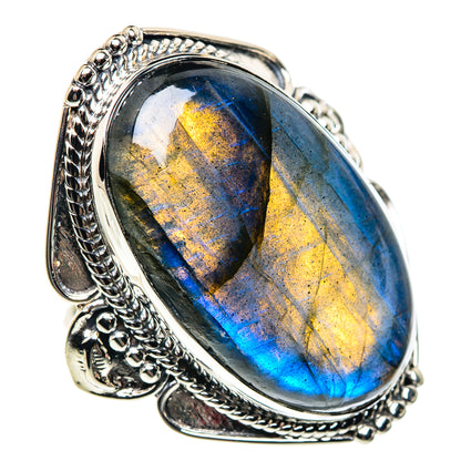 Oval labradorite sterling silver ring with blue and gold iridescent glow, ornate setting