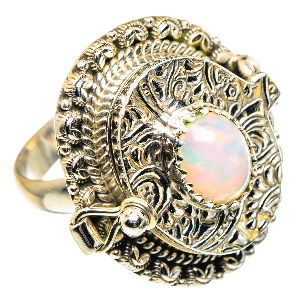 Sterling silver opal ring with round iridescent center and detailed vintage-style setting
