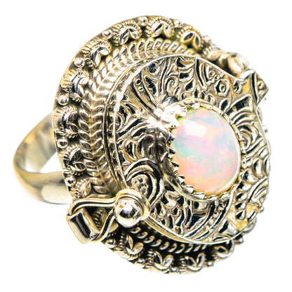 Sterling silver opal ring with round iridescent center and detailed vintage-style setting
