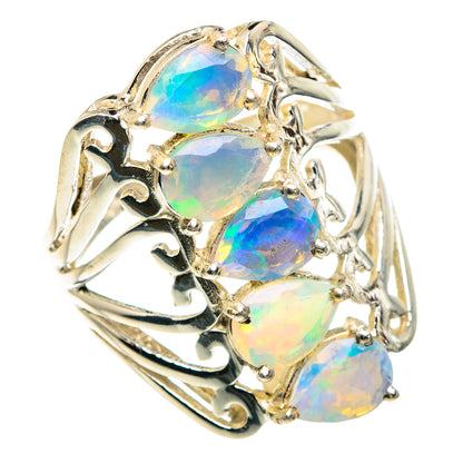 Silver ring featuring multiple oval opal stones with ornate openwork setting