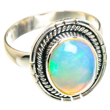 Sterling silver opal ring with oval Ethiopian opal cabochon and ornate bezel setting