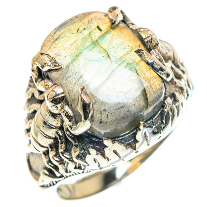 Ornate silver skull ring with large oval labradorite showing blue and gold iridescence