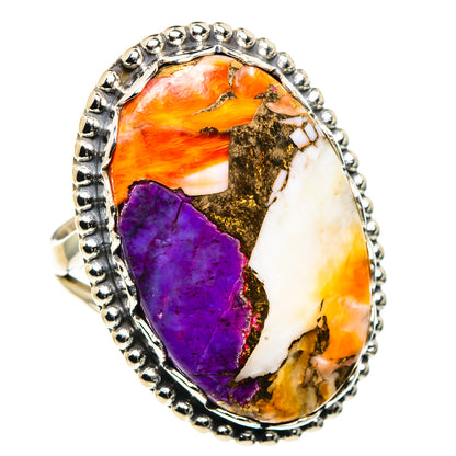 Oval stone ring with purple, orange, copper, and white inlay, silver bead border