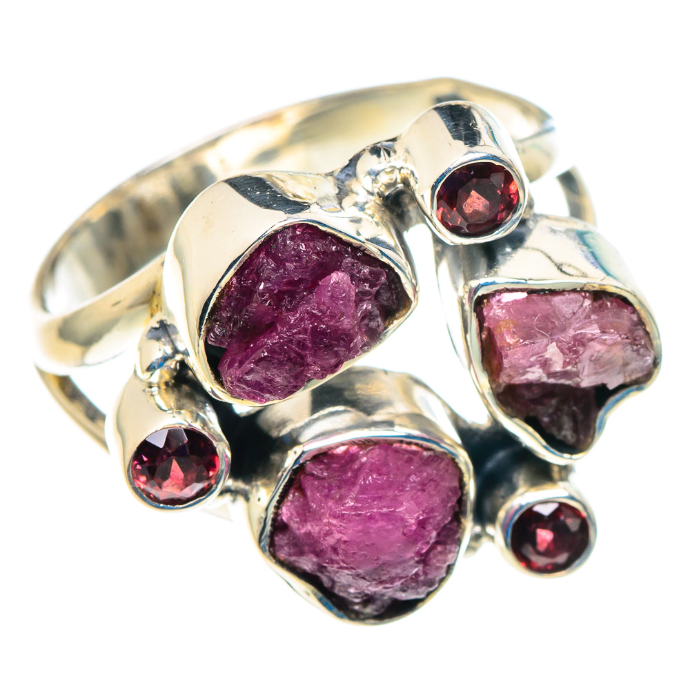 Sterling silver ring with three rough pink stones and four red round accents