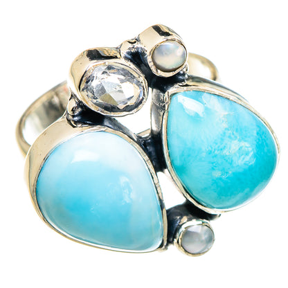 Silver ring with oval larimar blue stones, a round clear stone, and pearl accents