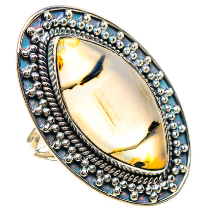 Sterling silver oval agate ring with raised bezel, bead rim, and prismatic blue