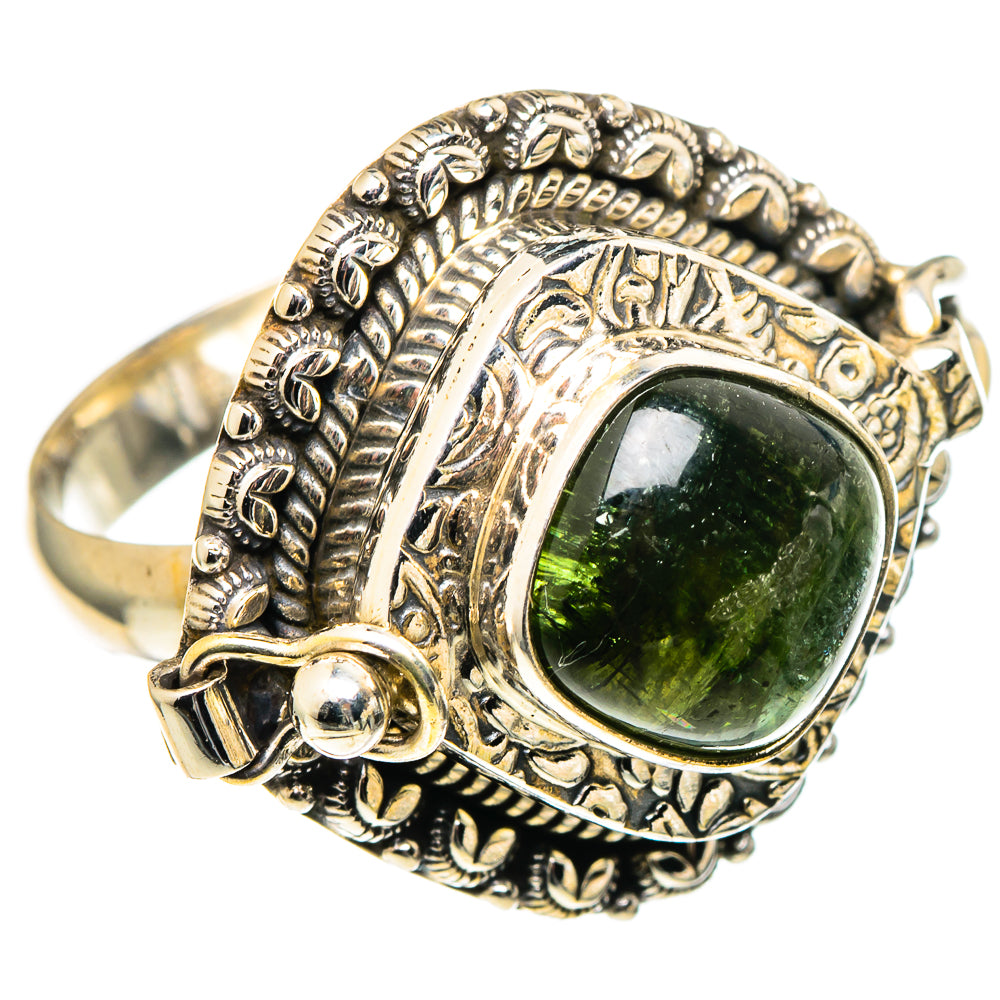 Ornate silver ring with oval dark-green tourmaline and leaf-like engraved band.