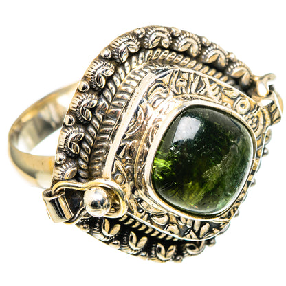 Ornate silver ring with oval dark-green tourmaline and leaf-like engraved band.