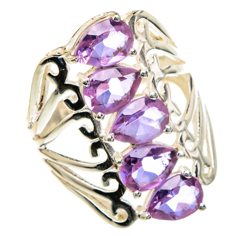 Gold-tone ring with three oval purple gemstones and ornate openwork sides