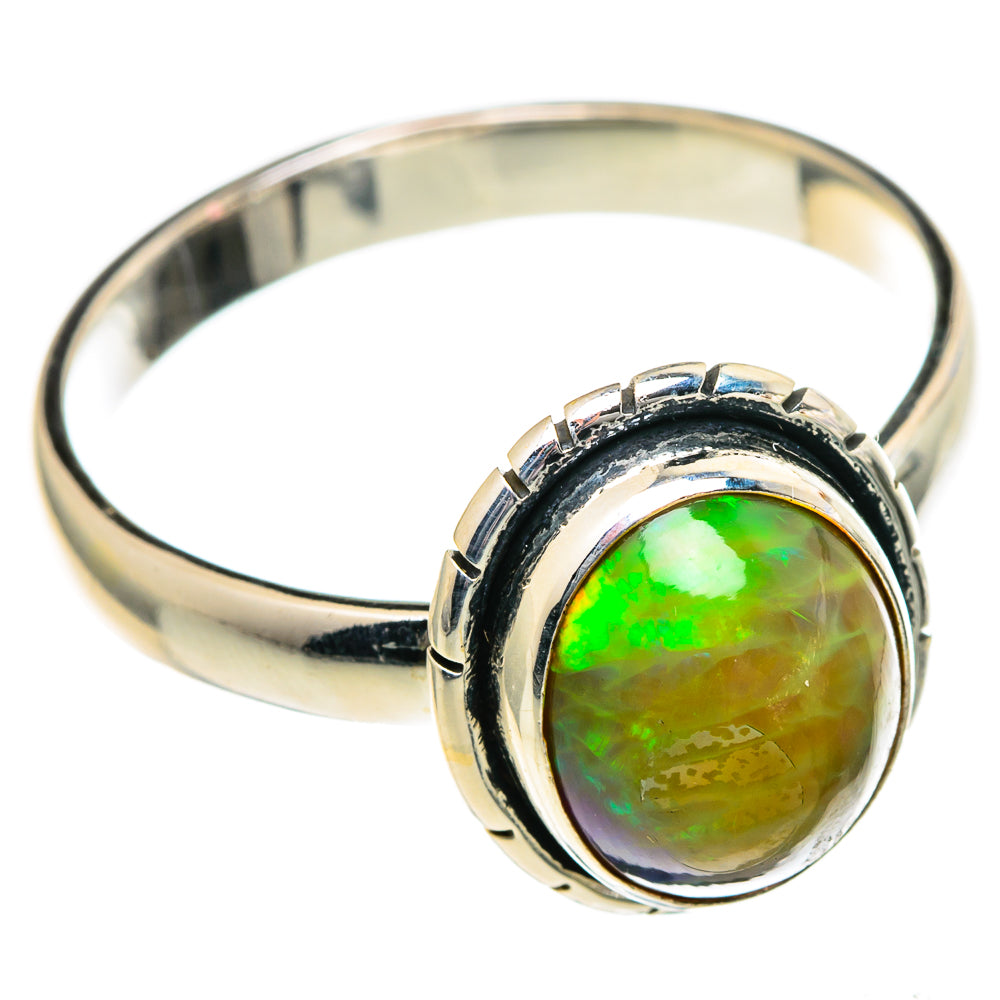 Sterling silver ring with round green-orange opal center and dark bezel accents