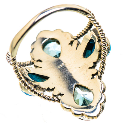 Sterling silver ring band with engraved filigree and blue oval stones across the top