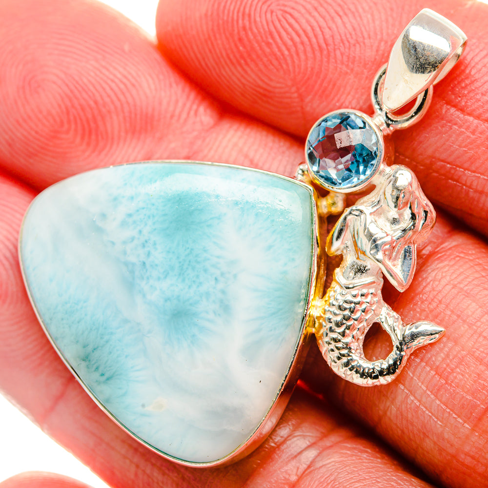 Sterling silver pendant with blue cabochon, round blue stone, and seahorse charm