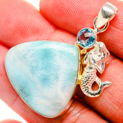 Sterling silver pendant with blue cabochon, round blue stone, and seahorse charm
