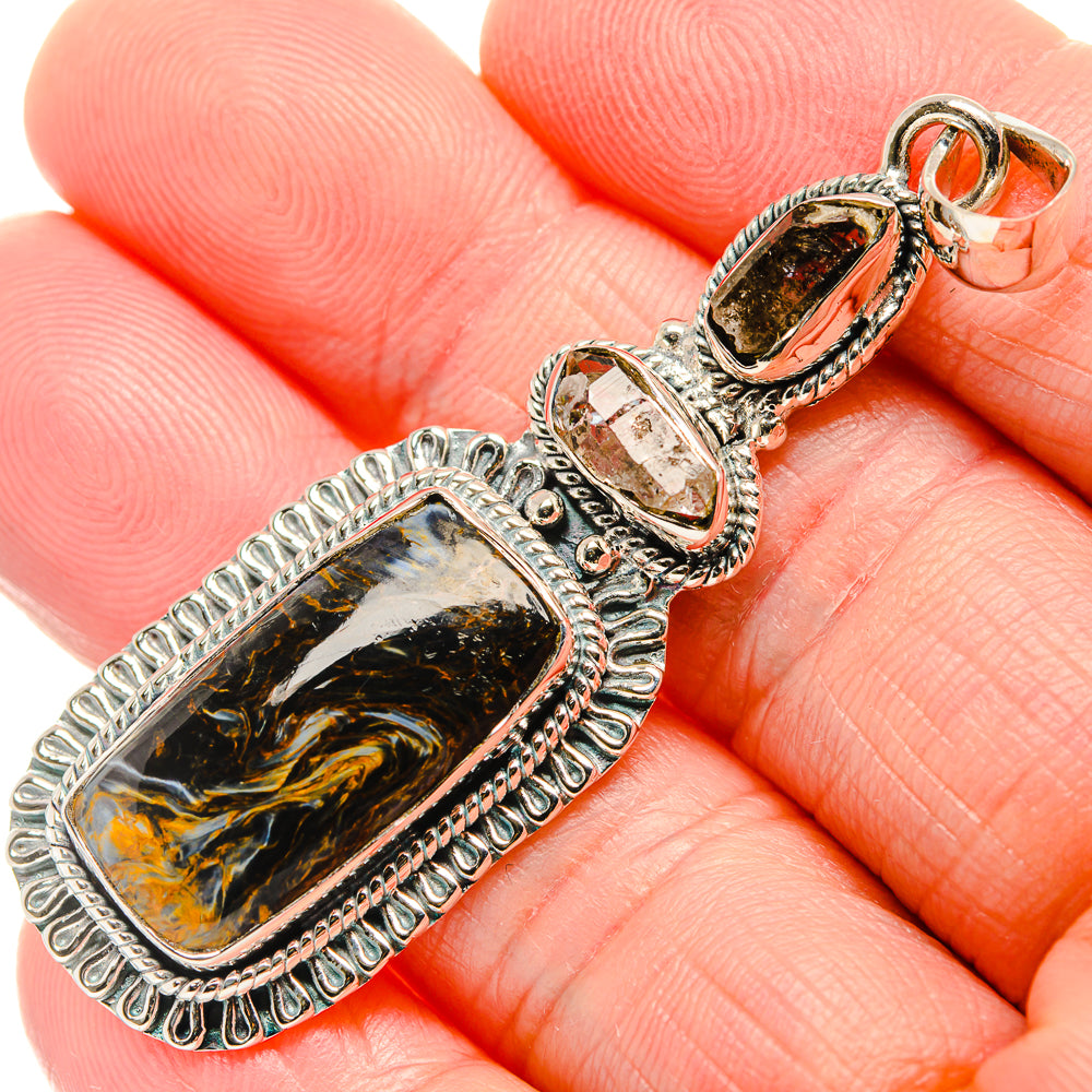 Sterling silver pendant with rectangular pietersite cabochon and clear stone bail