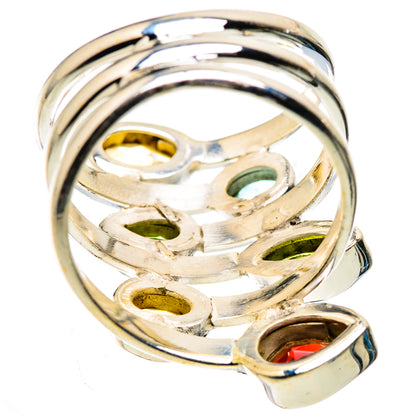 Silver ring underside view with oval yellow, green, and red stones set in metal