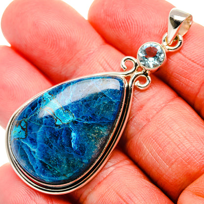 Sterling silver blue teardrop pendant with round blue topaz accent, close-up