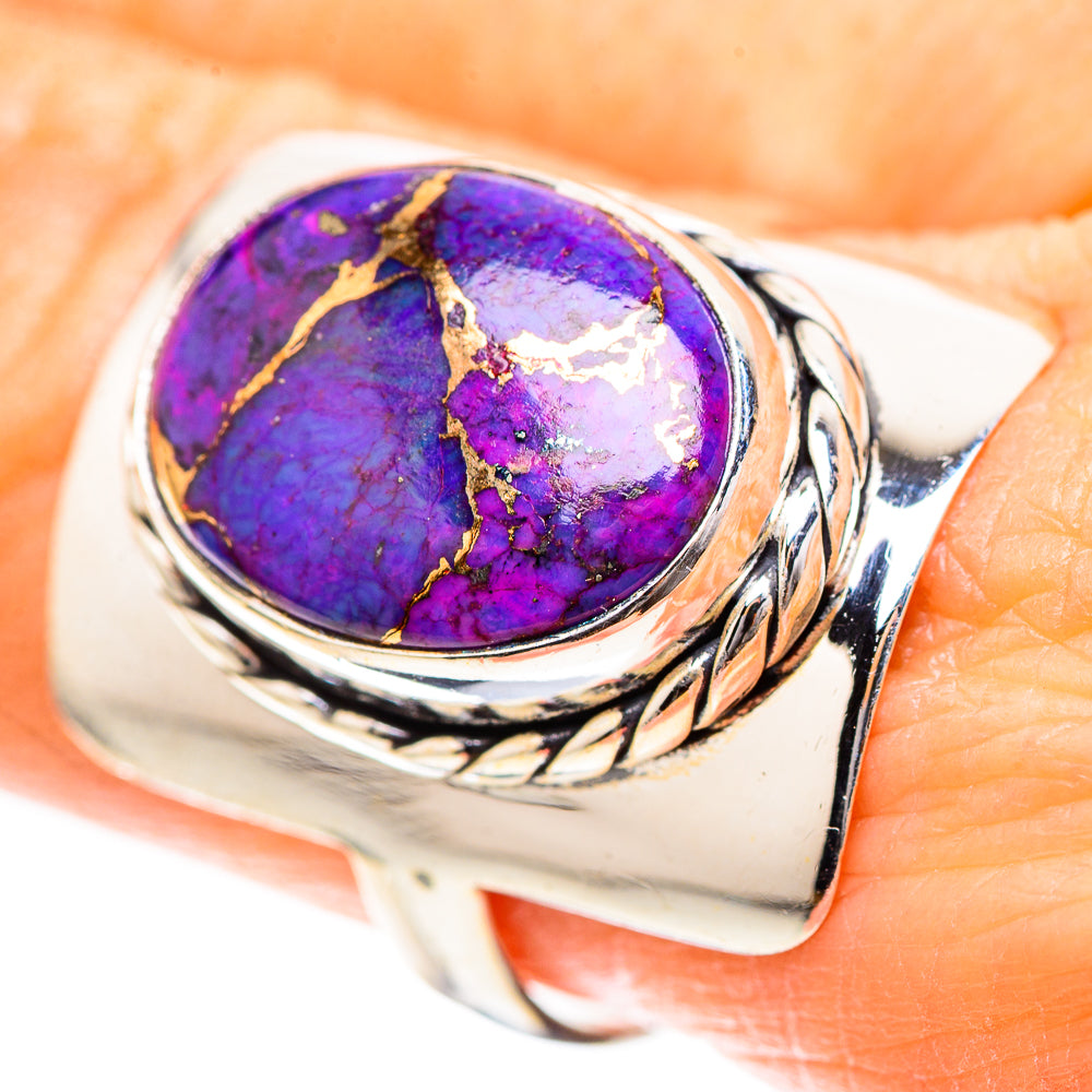 Sterling silver ring with oval purple turquoise-style gemstone and braided metal band.