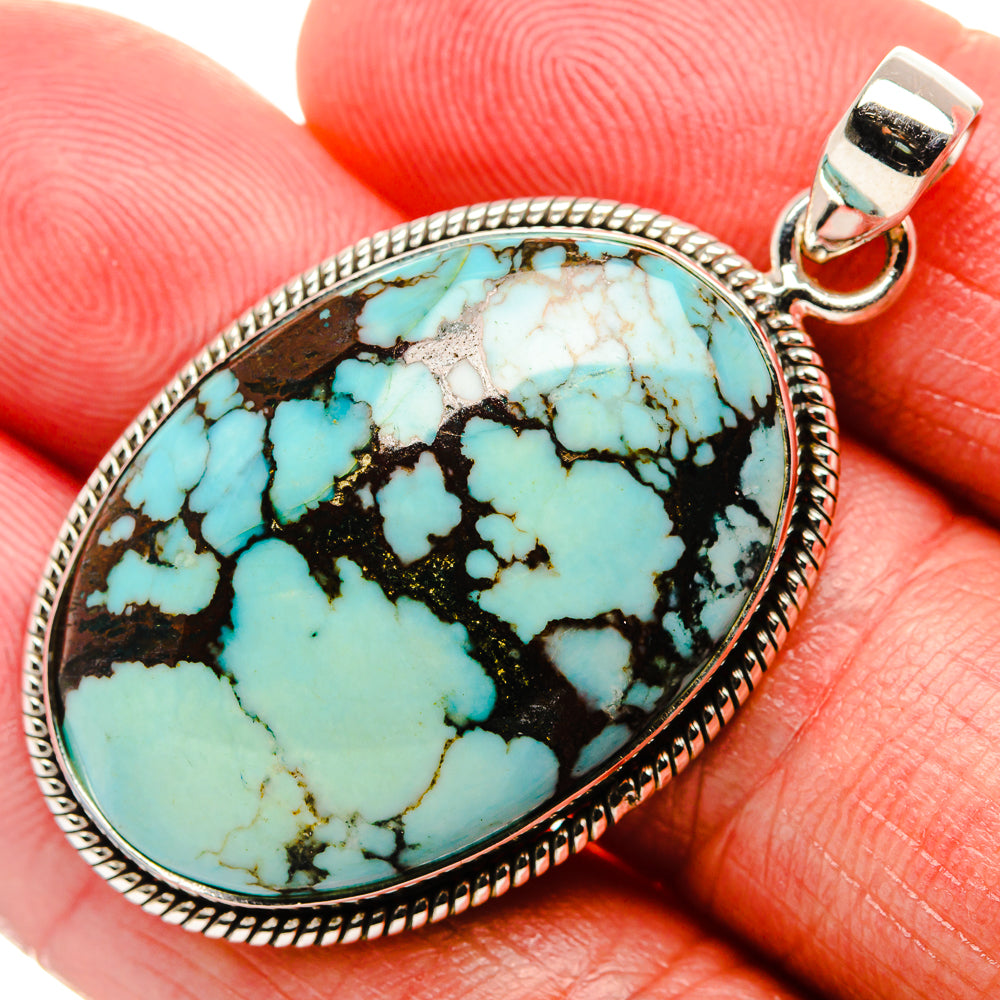 Turquoise oval pendant with sterling-silver bezel and bail, blue with black matrix veining