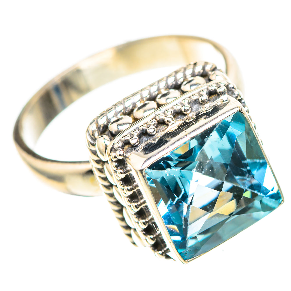 Sterling silver ring with blue topaz cushion gemstone and ornate textured band