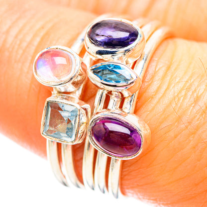 Close-up sterling silver ring with oval purple and blue gems, plus moonstone and square stone