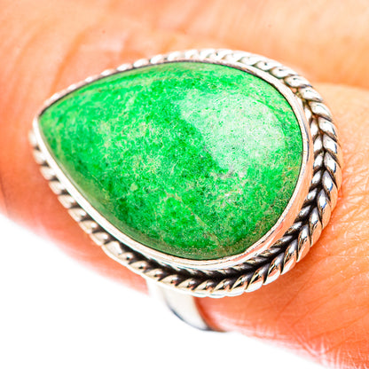 Sterling silver ring with green teardrop stone, silver border and rope-style details