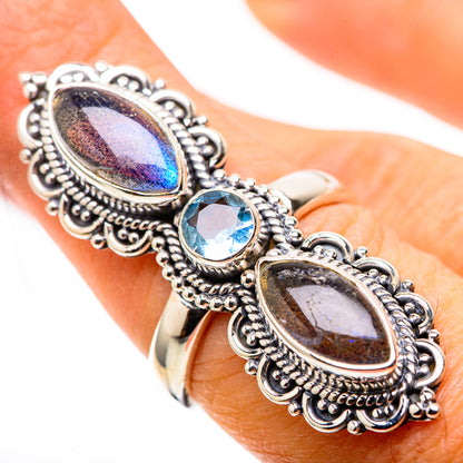 Silver ring with oval labradorite and blue topaz stones, ornate bezel setting