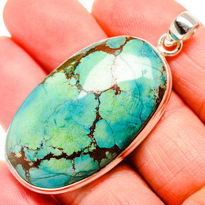 Oval turquoise stone pendant with sterling silver bezel and loop bail