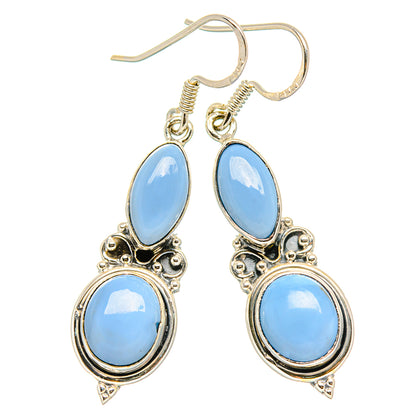 925 sterling silver opal drop earrings with light-blue oval stones and ornate teardrop detail.