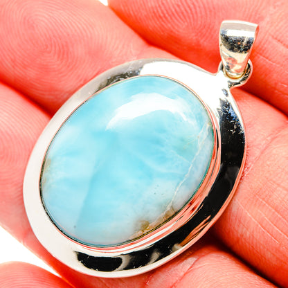 Sterling silver larimar oval pendant with polished bezel and top bail, close-up